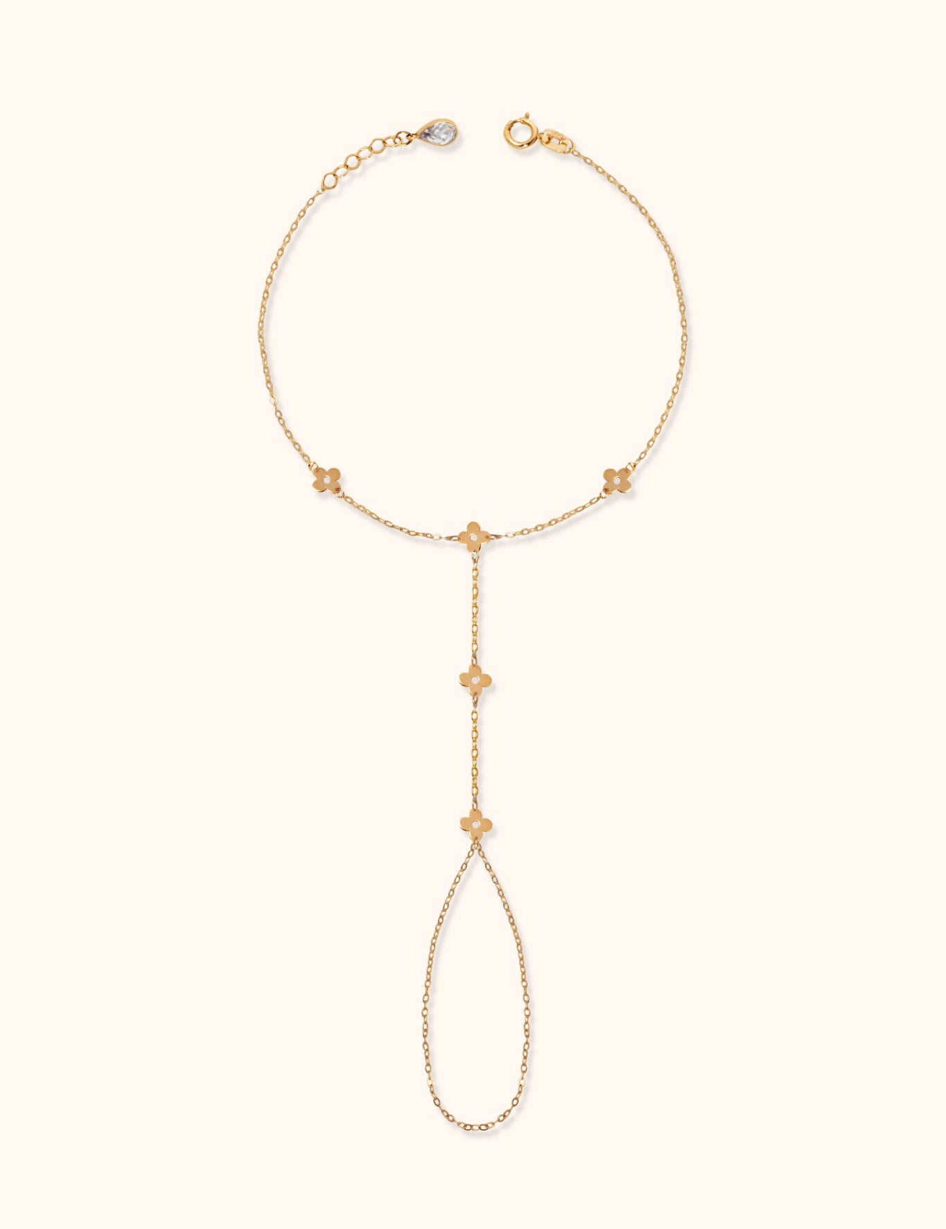 Gold floral hand chain bracelet with finger loop and delicate flower charms