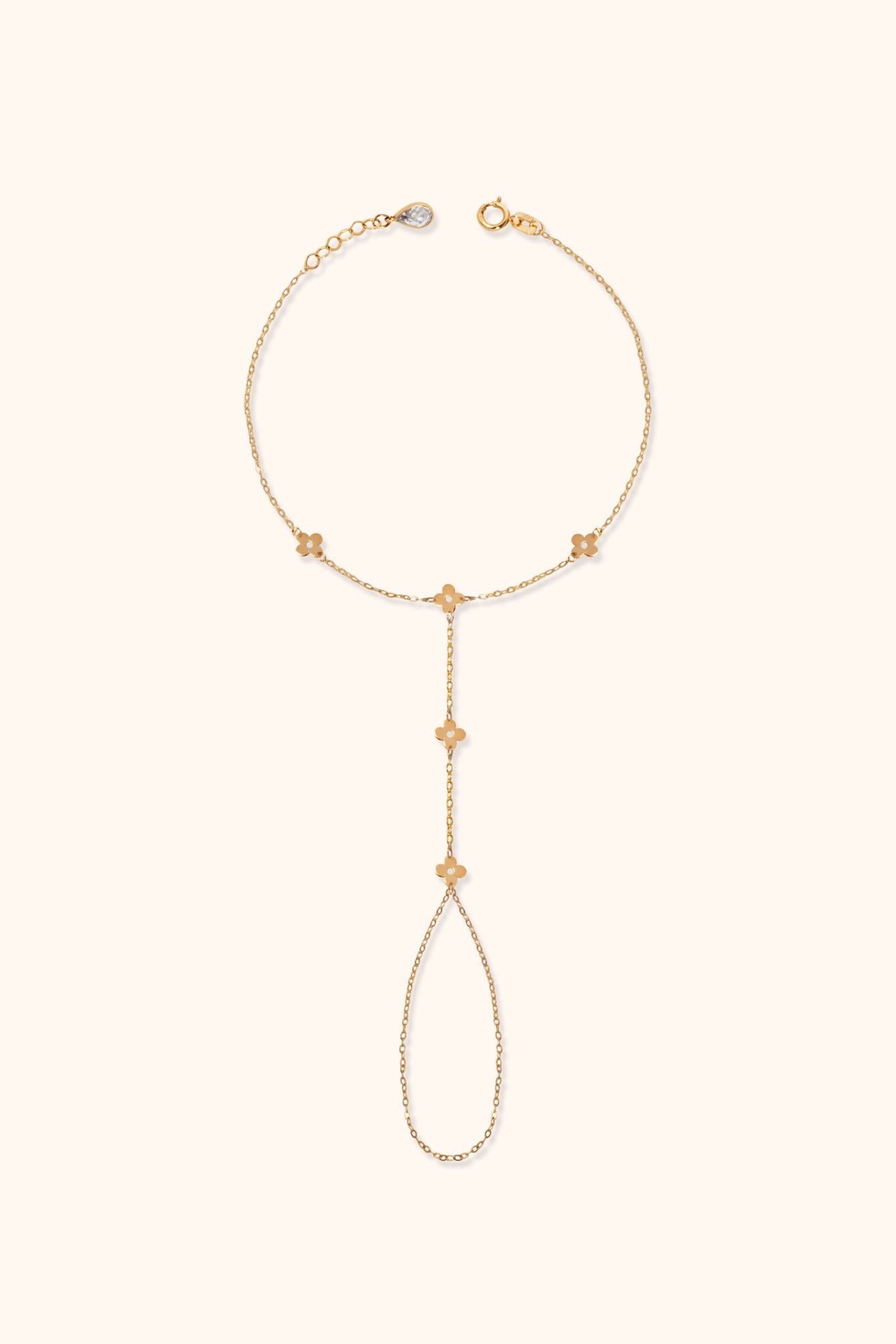 Gold floral hand chain bracelet with finger loop and delicate flower charms