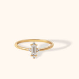 14K gold ring with vertical baguette-cut center and four diamond accents in starburst design