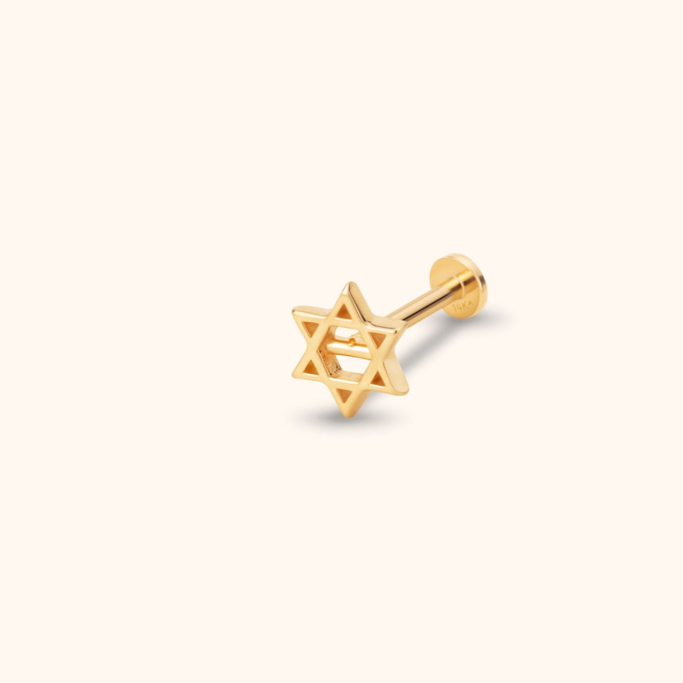 Close-up of a 14K solid gold Star of David tragus stud earring on a clean white background.