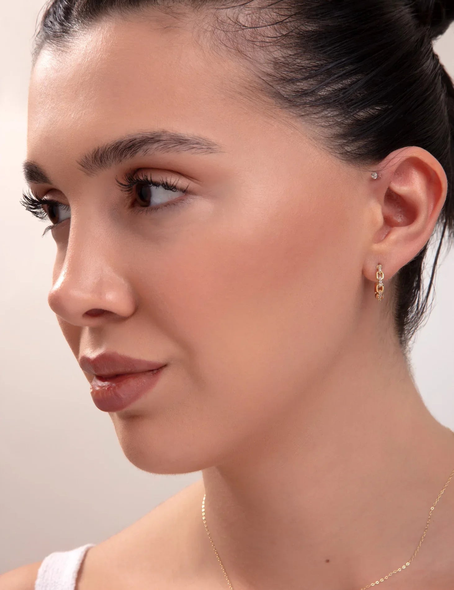 model wearing full gold jewelry set including necklace, bracelet, and two earring styles

