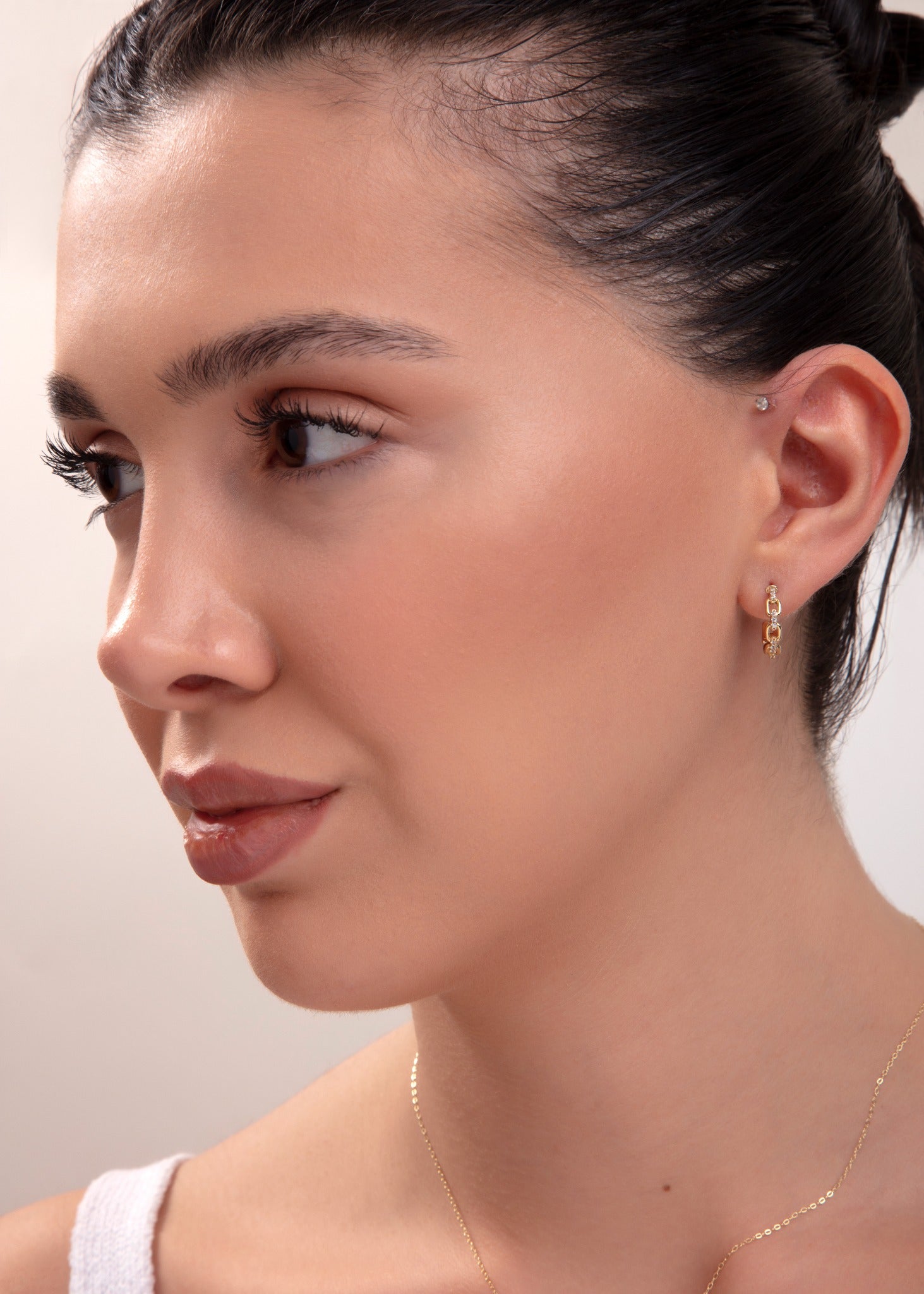 model wearing full gold jewelry set including necklace, bracelet, and two earring styles

