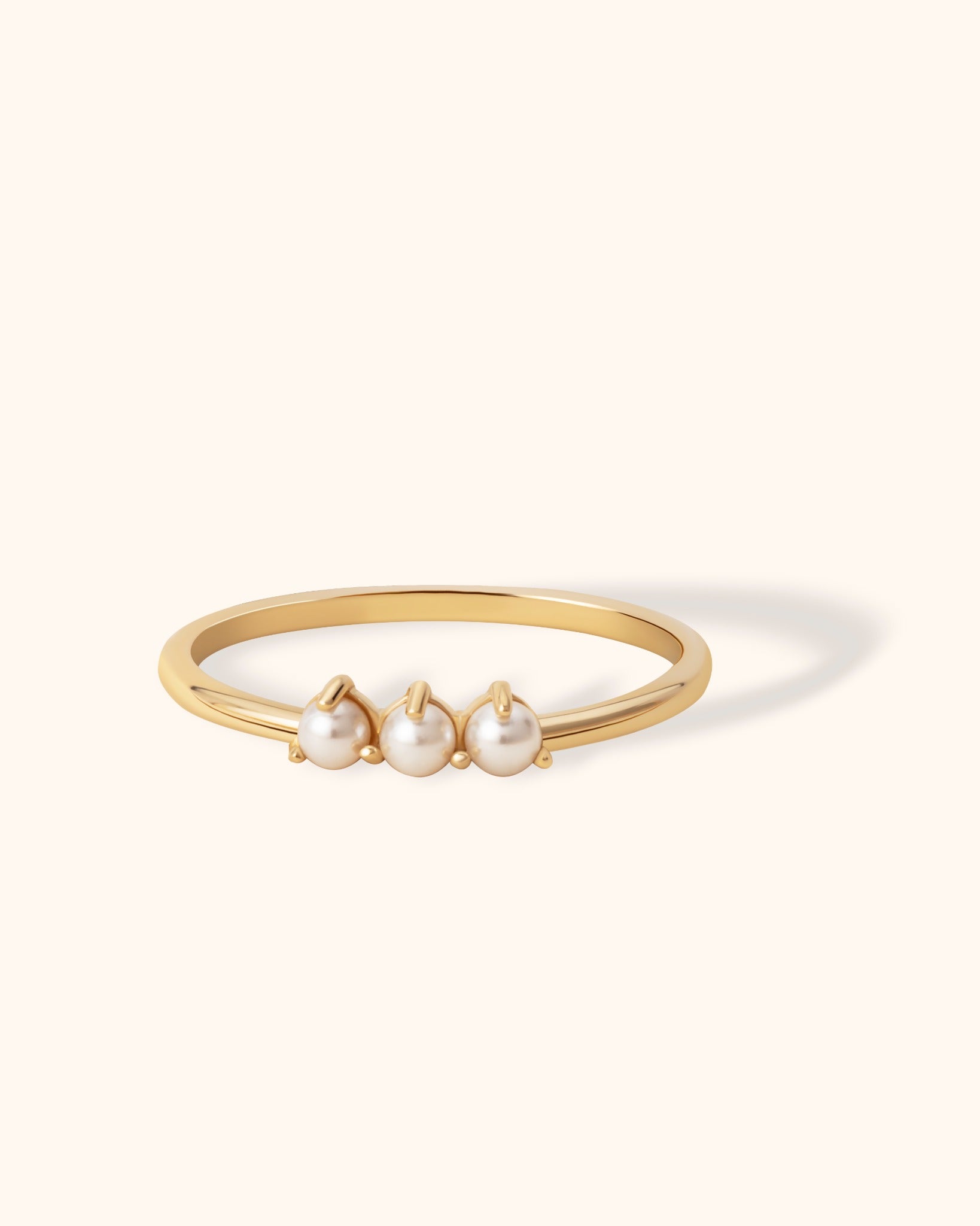 14K gold ring with three drop-shaped white pearls in a minimalist design
