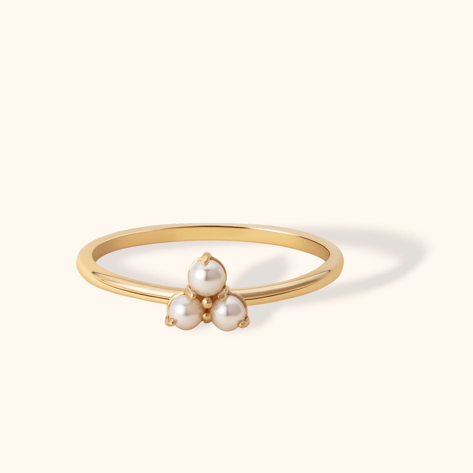 Delicate 14K gold ring featuring a trio of round pearls in a triangular cluster design