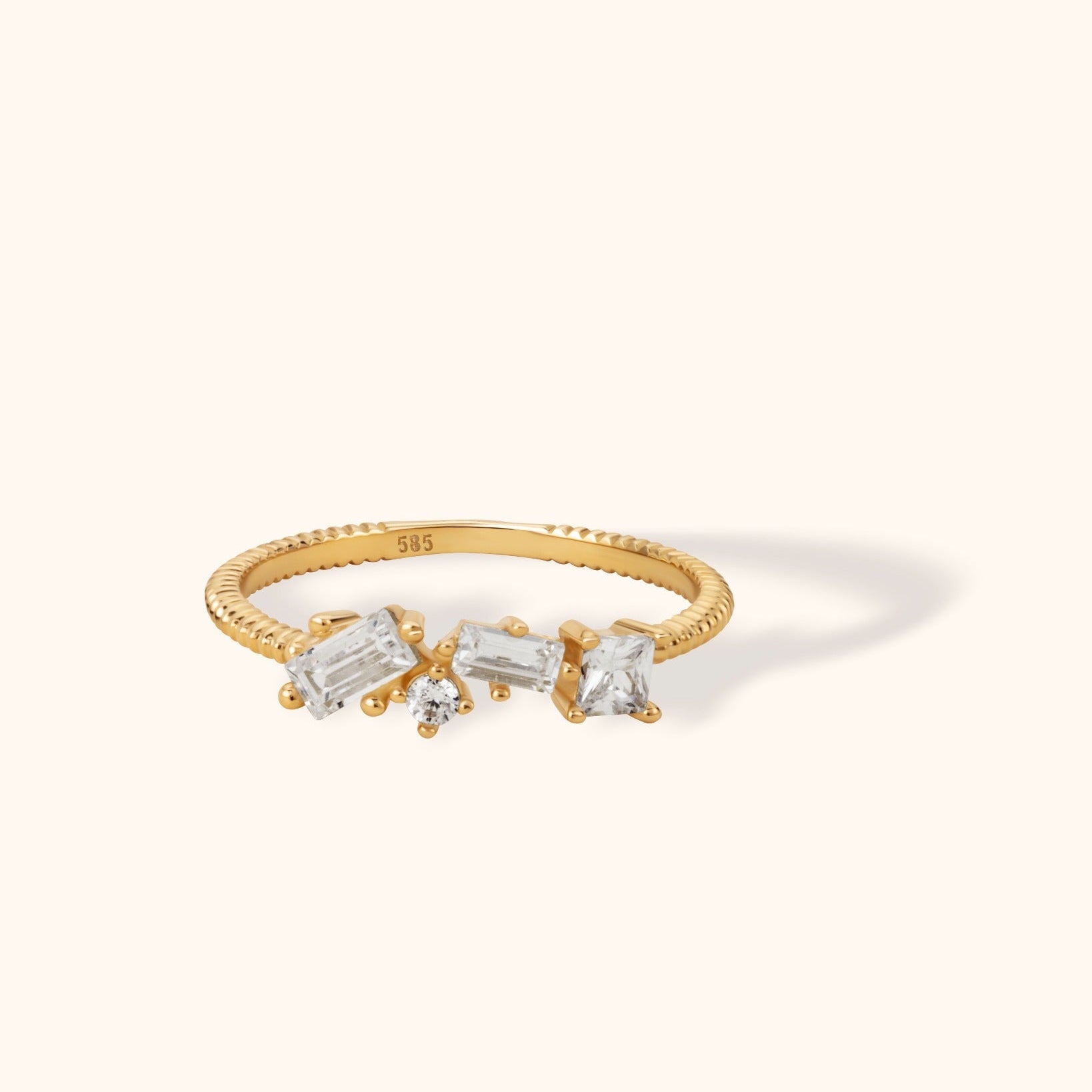 14K gold ring with mixed-cut diamonds on a textured gold band