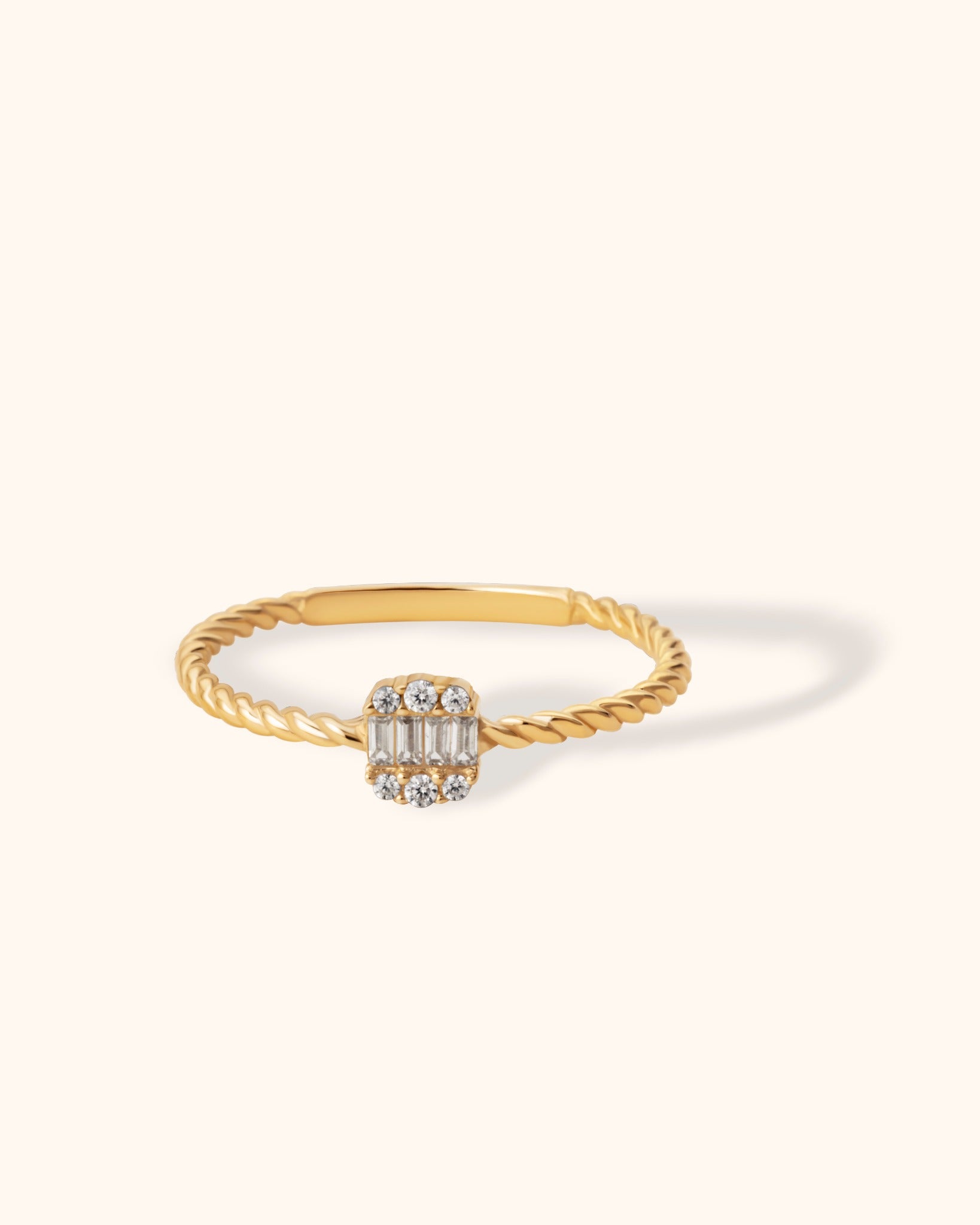 14K gold ring with twisted band and rectangular baguette and round zirconia cluster