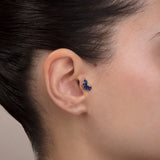 ear model wearing marquise blue stone gold tragus earring suitable for helix cartilage
