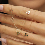 Minimalist 14K gold necklace with three evenly spaced clover charms,
