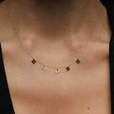 14K gold necklace featuring multiple four-leaf clover charms,
