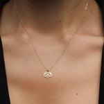 14K gold infinity heart necklace resting