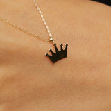 14K gold necklace with a polished crown-shaped pendant