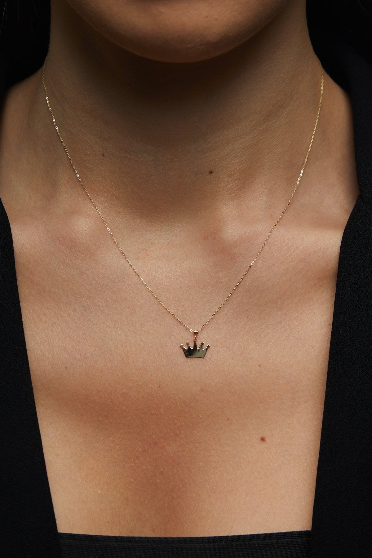 14K gold necklace with a polished crown-shaped pendant