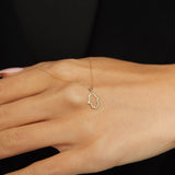 14K gold Hamsa hand necklace on emerald