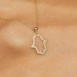 14K gold Hamsa hand necklace on emerald