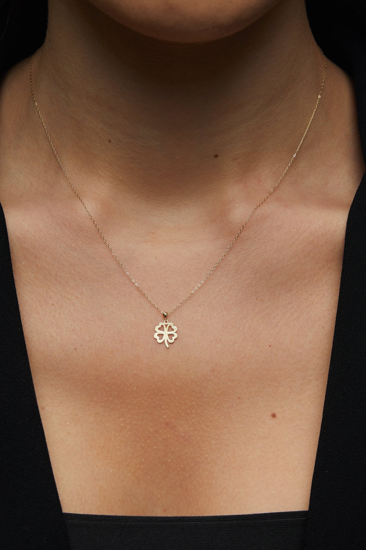14K solid gold four-leaf clover necklace, symbolizing luck and elegance