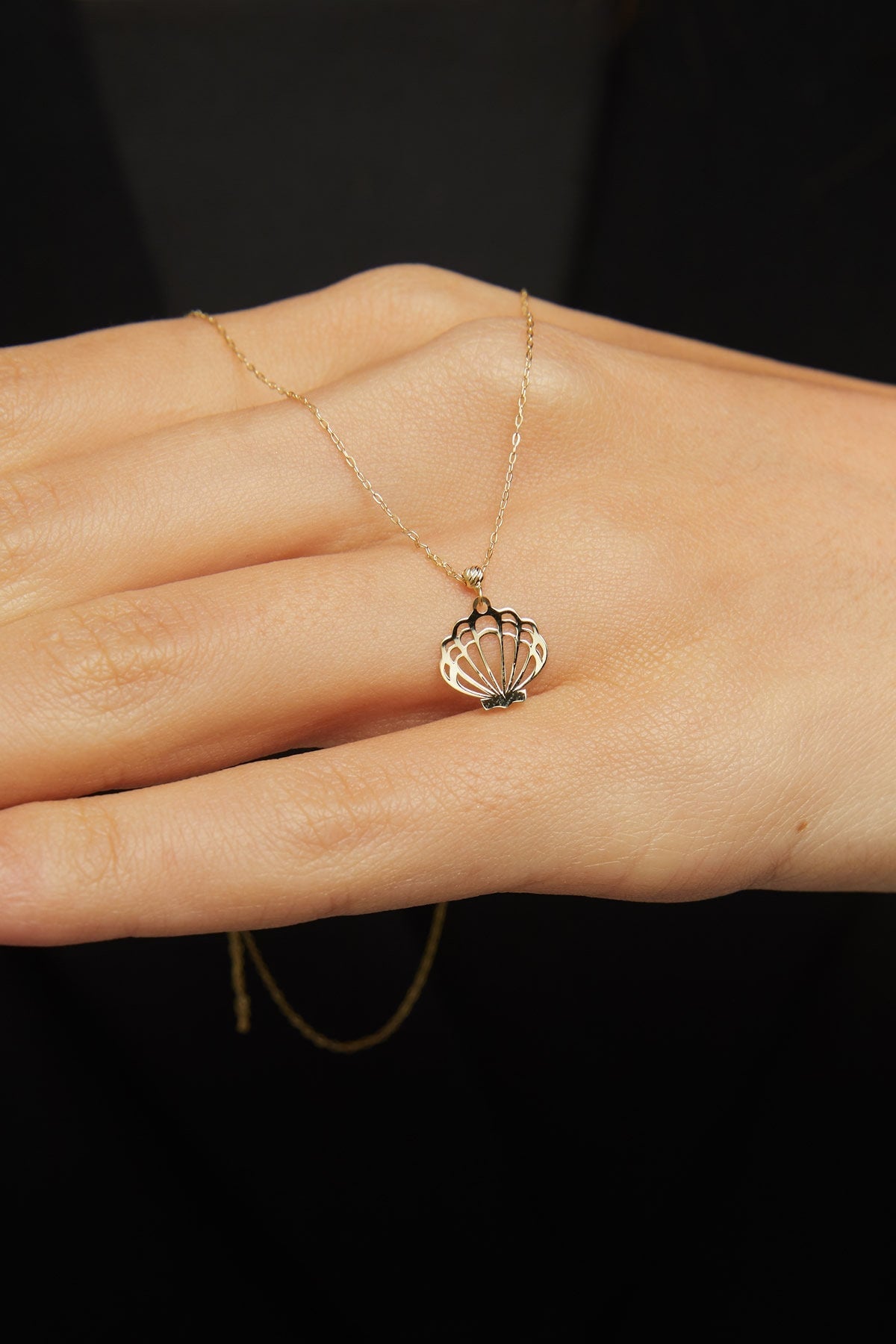 14K solid gold necklace featuring a delicate seashell pendant