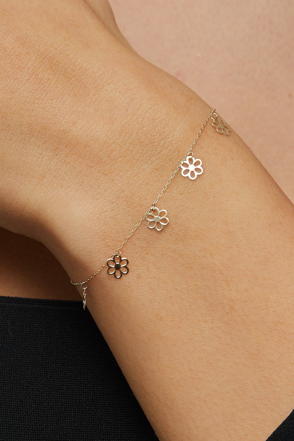 Dainty 14K gold bracelet with multiple hanging flower charms  – floral station design.
