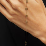 Dainty 14K gold bracelet with multiple hanging flower charms  – floral station design.