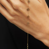 Dainty 14K gold bracelet with multiple hanging flower charms  – floral station design.