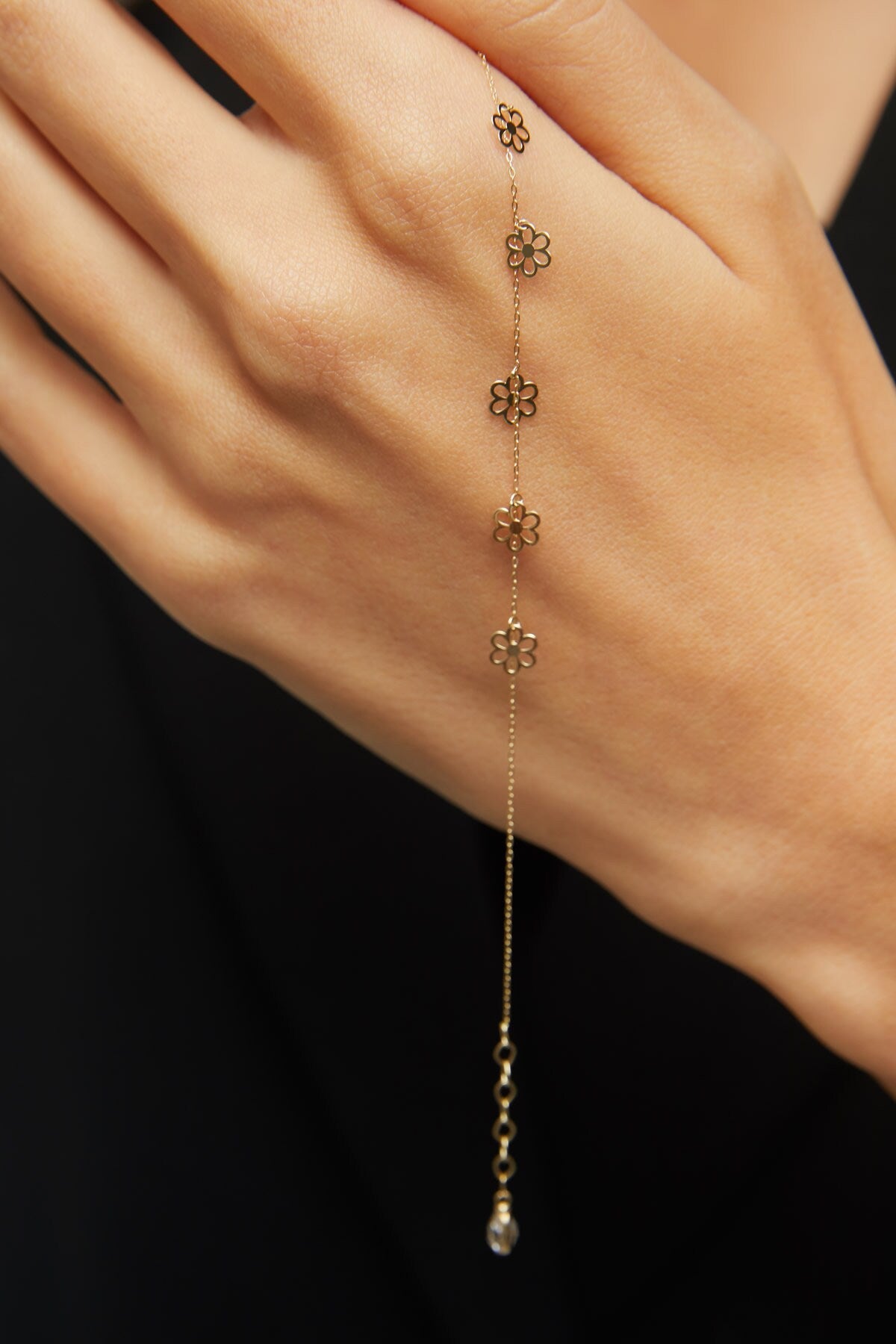 Dainty 14K gold bracelet with multiple hanging flower charms  – floral station design.