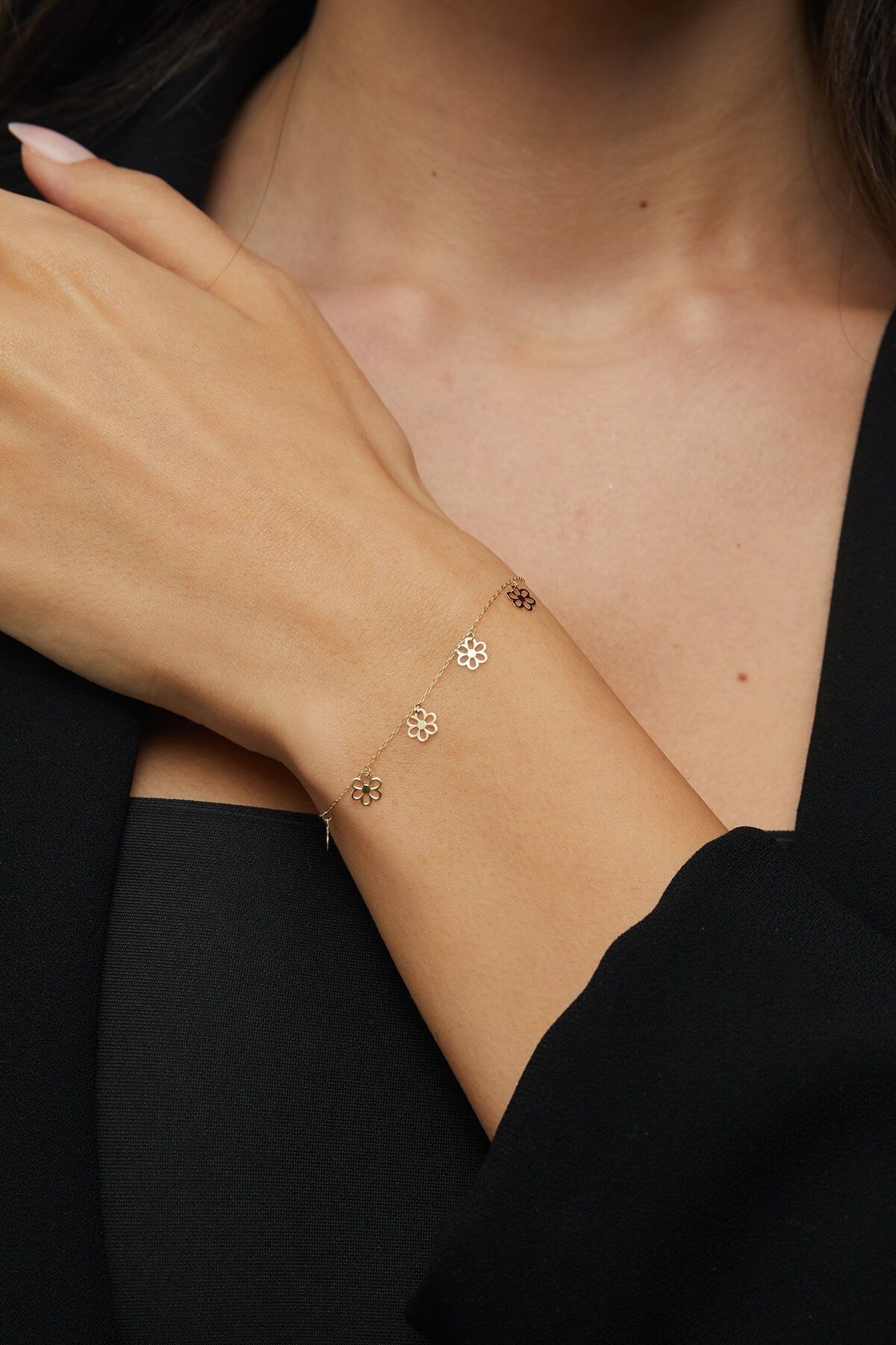 Dainty 14K gold bracelet with multiple hanging flower charms  – floral station design.