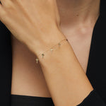 14K gold bracelet featuring five minimalist cross charms