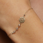 Elegant 14K gold bracelet featuring a snowflake charm and crystal bead accents