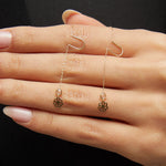 14K gold flower threader earrings with crystal detail worn on model