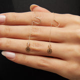 14K gold flower threader earrings with crystal detail worn on model