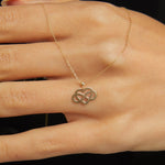 14K gold infinity heart necklace resting