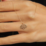 14K gold infinity heart necklace resting