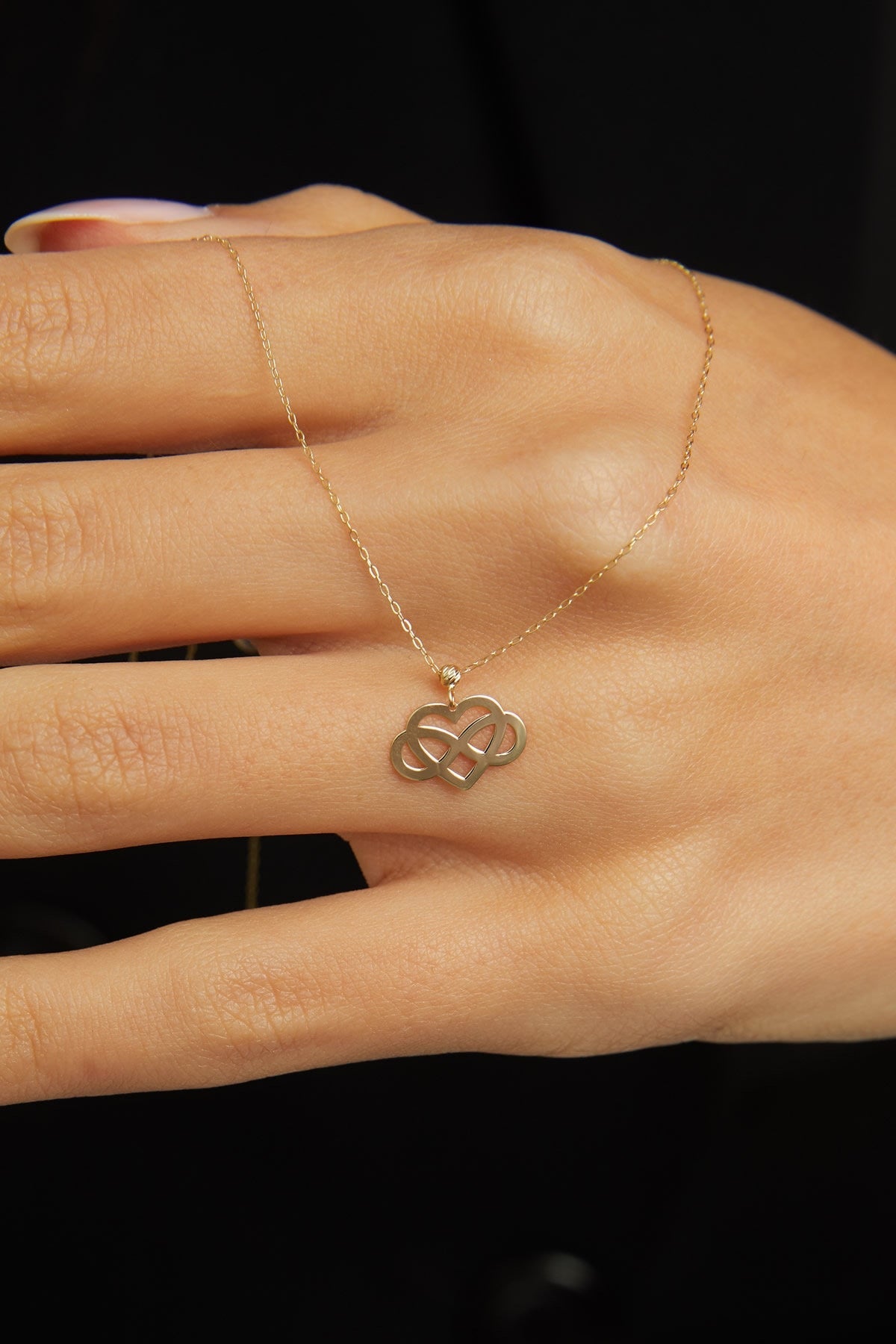 14K gold infinity heart necklace resting