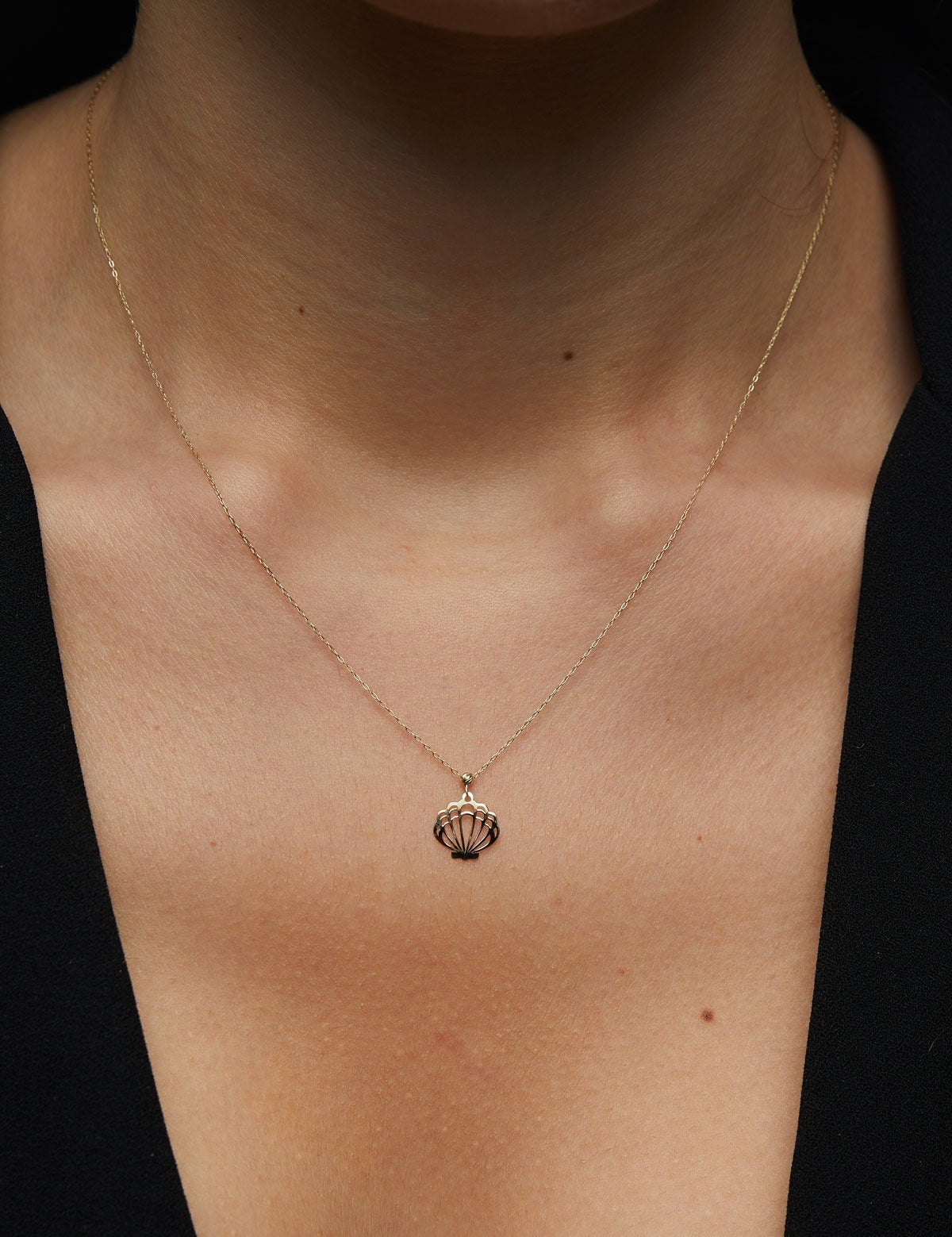 14K solid gold necklace featuring a delicate seashell pendant