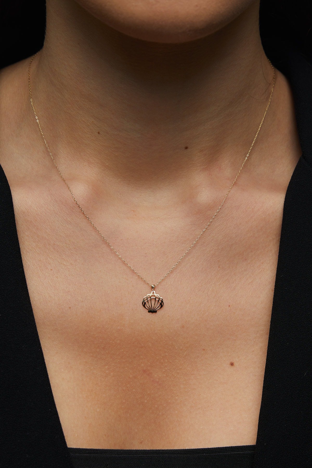 14K solid gold necklace featuring a delicate seashell pendant