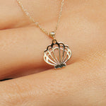 14K solid gold necklace featuring a delicate seashell pendant