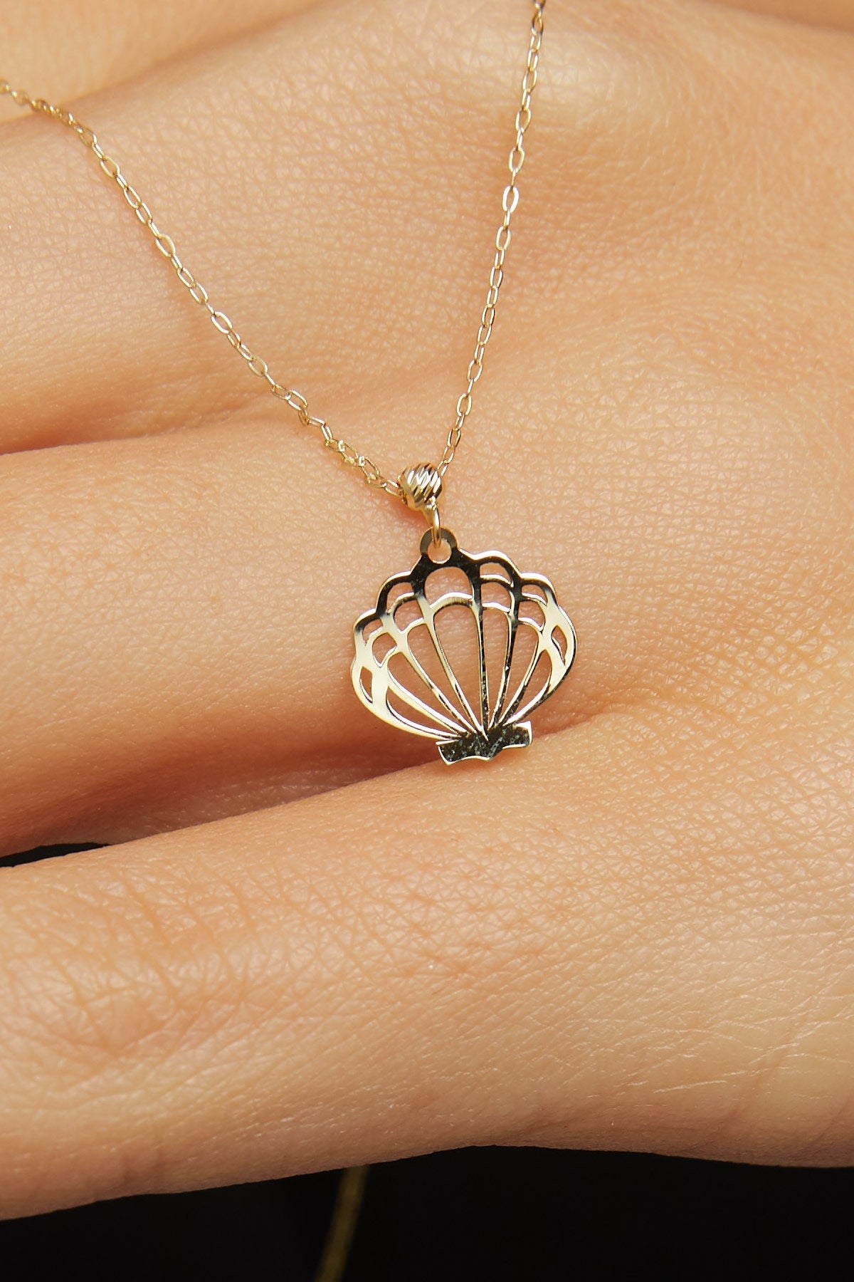 14K solid gold necklace featuring a delicate seashell pendant