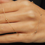 Minimalist 14K solid gold necklace with round beads spaced along a fine chain,
