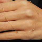 Minimalist 14K solid gold necklace with round beads spaced along a fine chain,
