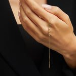 14K gold bracelet with four-leaf clover charm and gemstone details