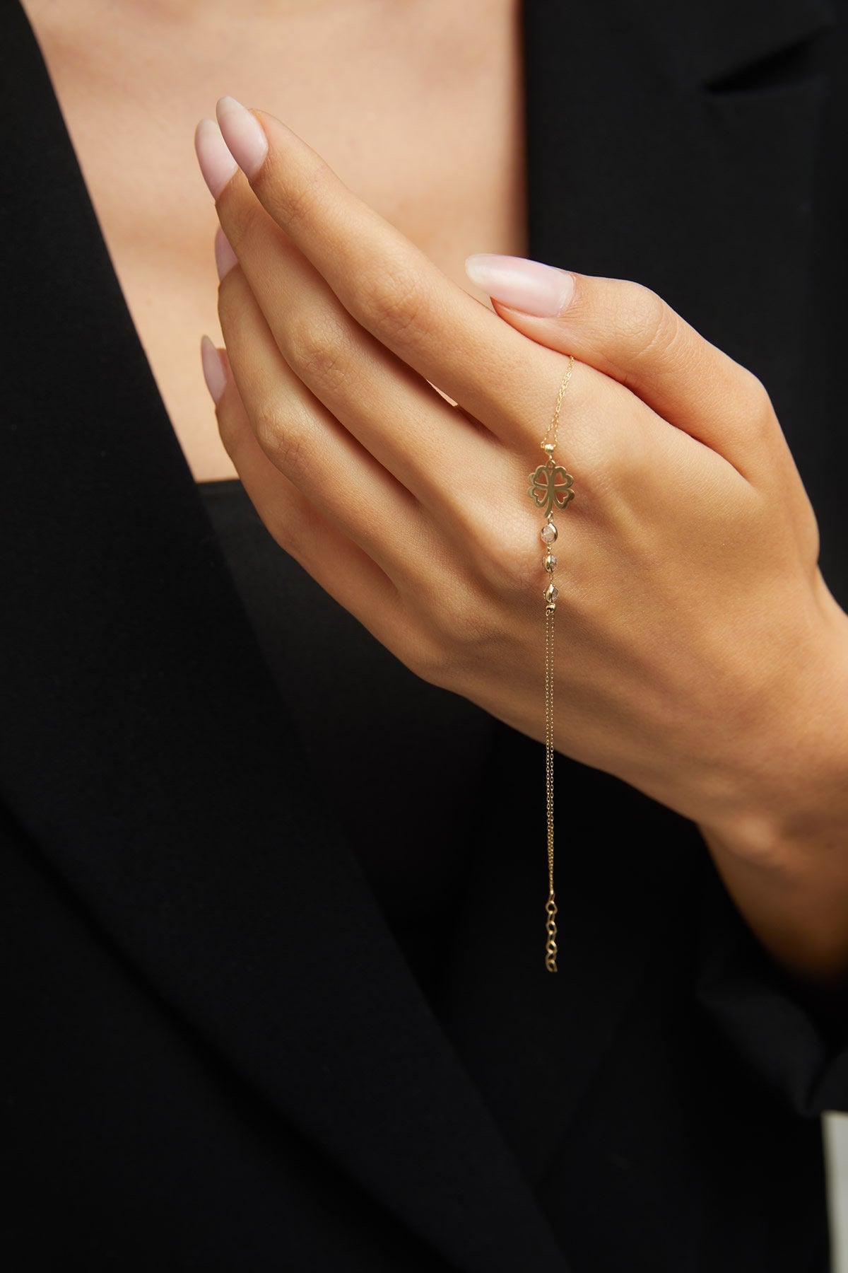 14K gold bracelet with four-leaf clover charm and gemstone details