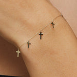 14K gold bracelet featuring five minimalist cross charms