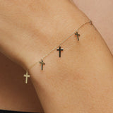 14K gold bracelet featuring five minimalist cross charms