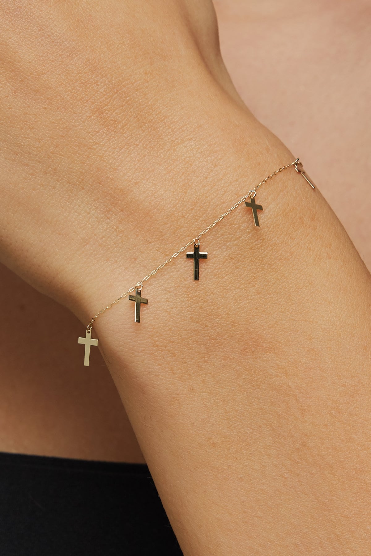 14K gold bracelet featuring five minimalist cross charms