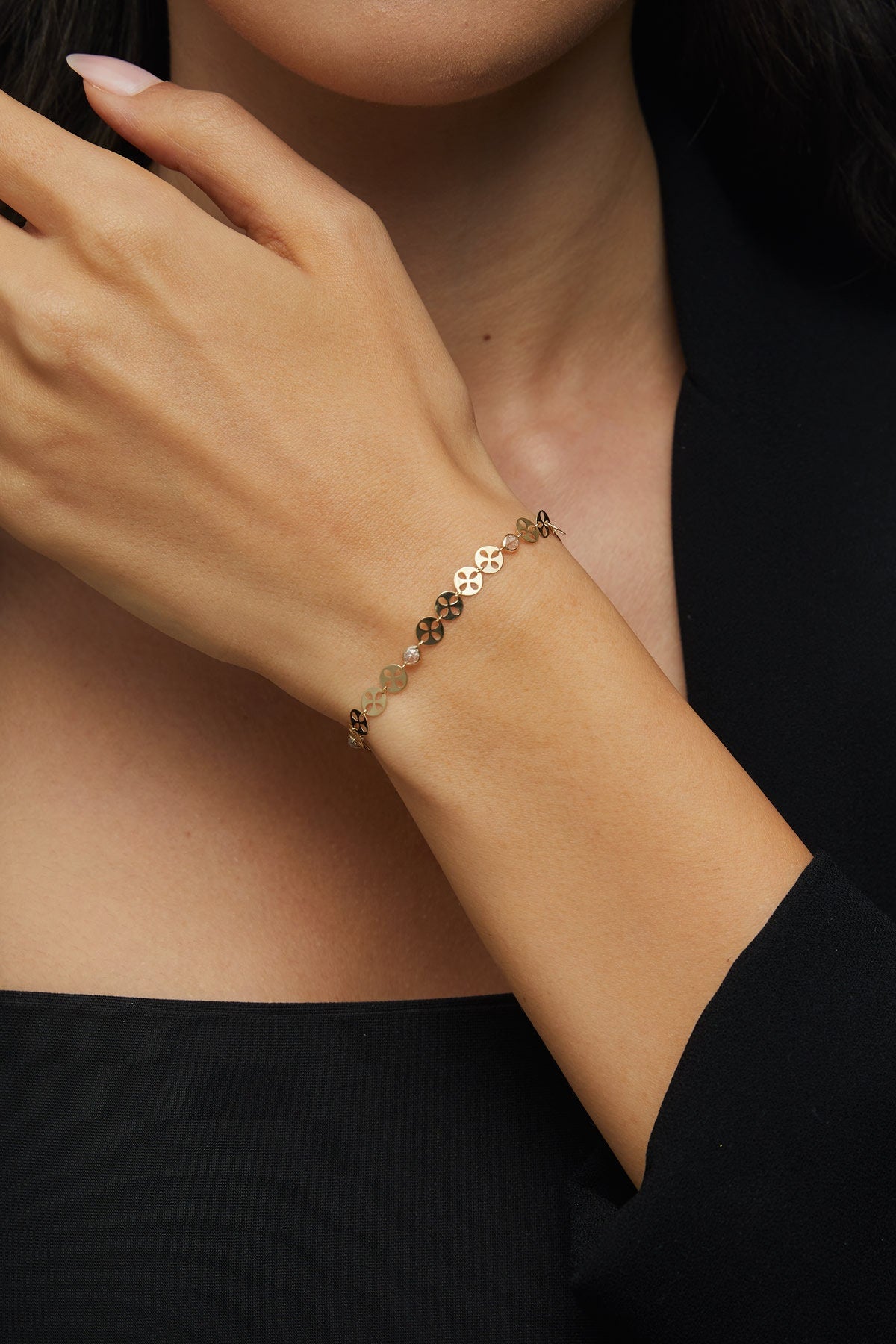 14K gold bracelet with circular disc charms and crystal beads displayed