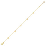 14K gold bracelet with delicate open star charms on green fabric