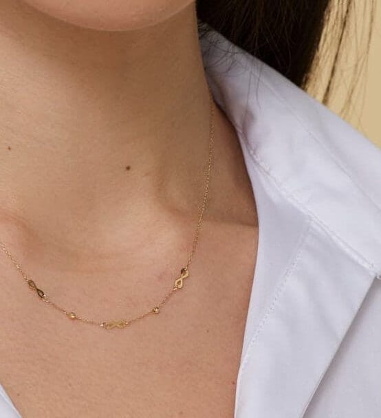Minimalist 14K gold necklace with three infinity symbol charms