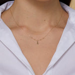 Minimalist 14K gold necklace with an infinity pendant and textured beaded chain,