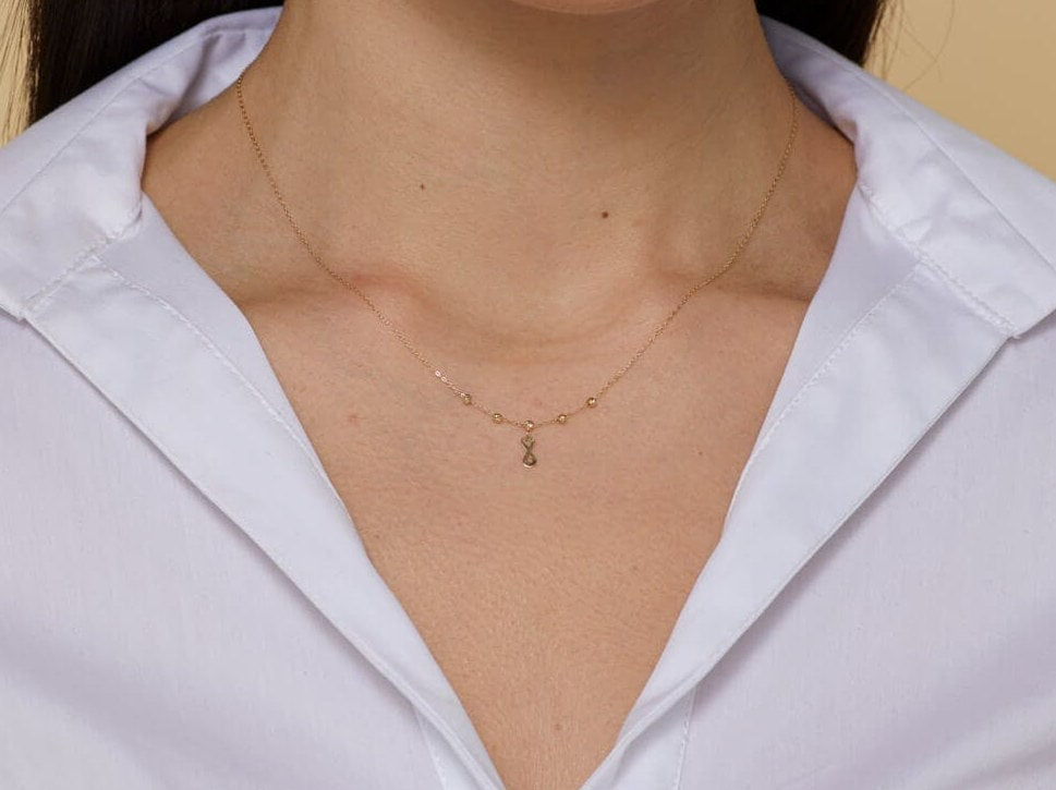 Minimalist 14K gold necklace with an infinity pendant and textured beaded chain,