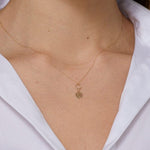 14K gold four leaf clover necklace with circular loop detail, – elegant and symbolic.