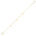 Close-up of a 14K gold bracelet with hollow star charms and gold beads
